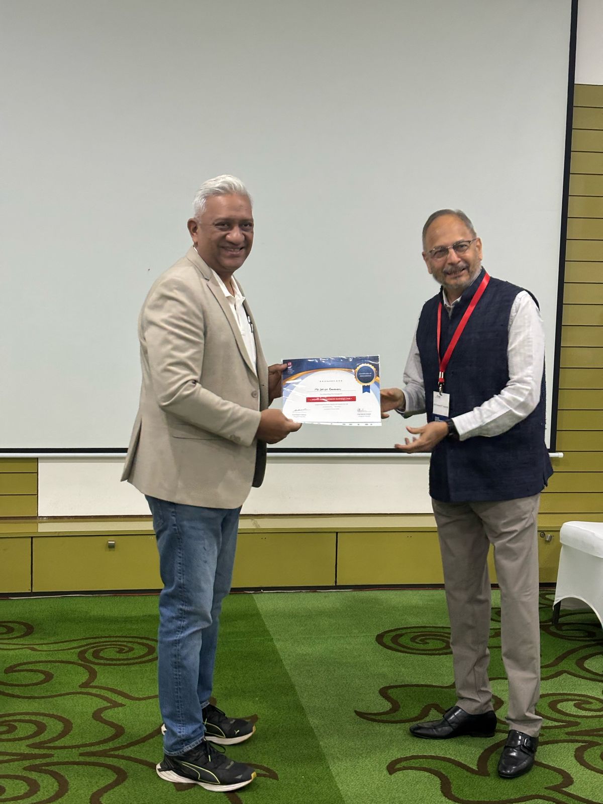 Satish Ramanan receiving a certificate at a leadership event