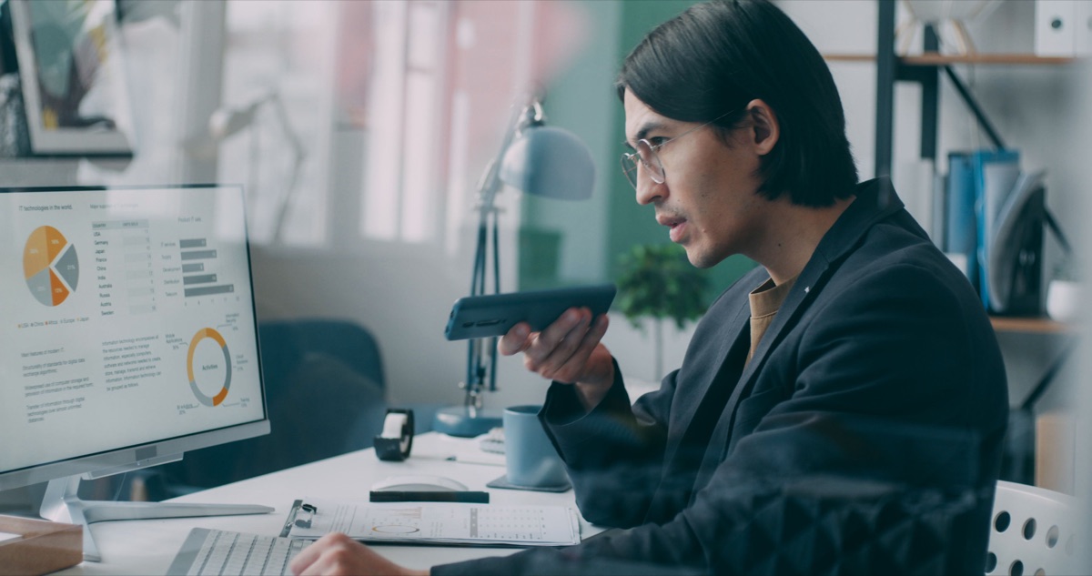 Professional reviewing operational data on a computer screen